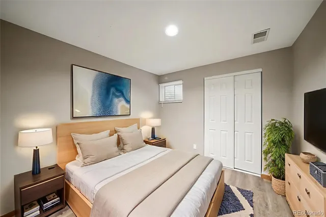 a bedroom with a bed and a potted plant