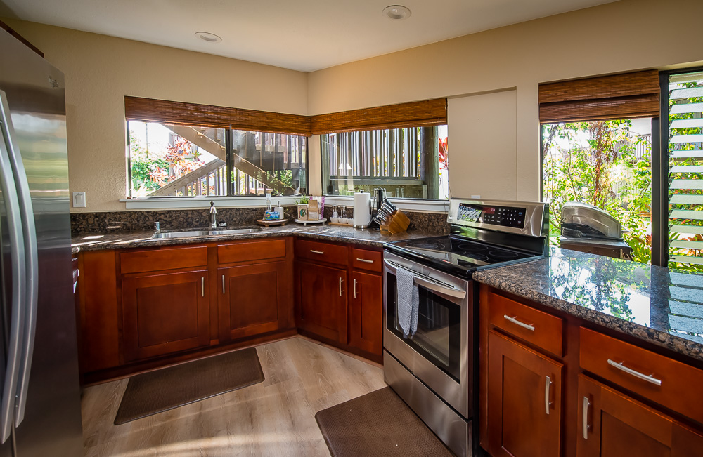 3920 Wyllie Road, Unit 9A Princeville, HI 96722 - Photo 13 of 30 a kitchen with a sink stove and cabinets