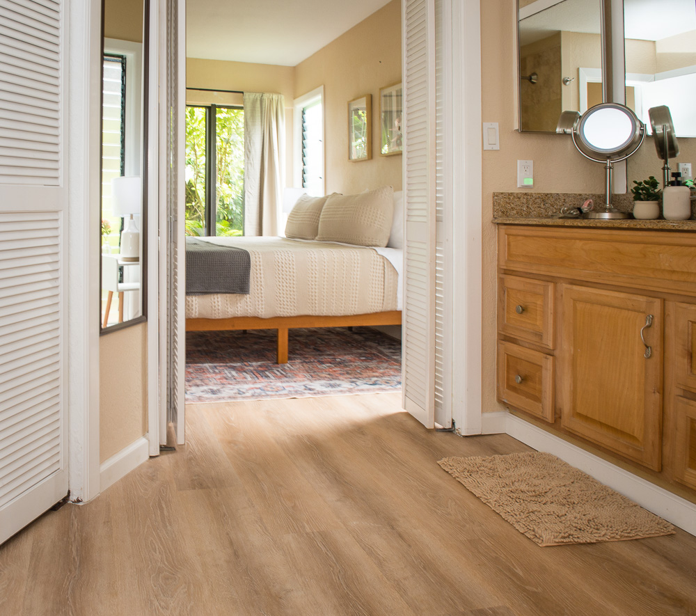 3920 Wyllie Road, Unit 9A Princeville, HI 96722 - Photo 22 of 30 a view of a bedroom with a bed and wooden floor