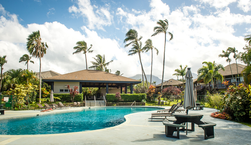 3920 Wyllie Road, Unit 9A Princeville, HI 96722 - Photo 29 of 30 a view of a patio with a table and chairs under an umbrella