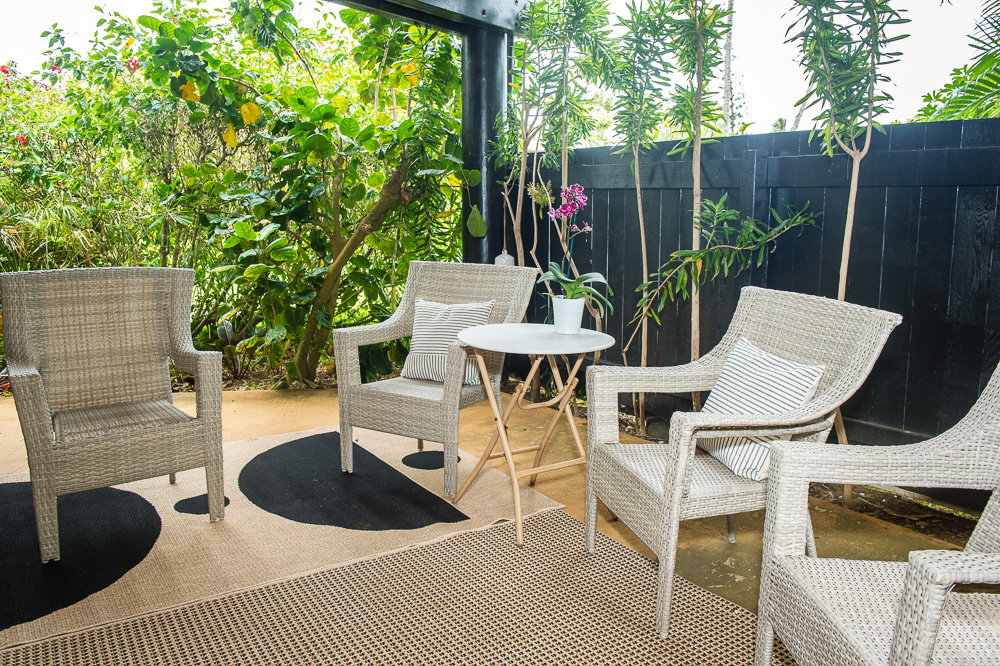 3920 Wyllie Road, Unit 9A Princeville, HI 96722 - Photo 3 of 30 a view of a patio with couches table and chairs and potted plants
