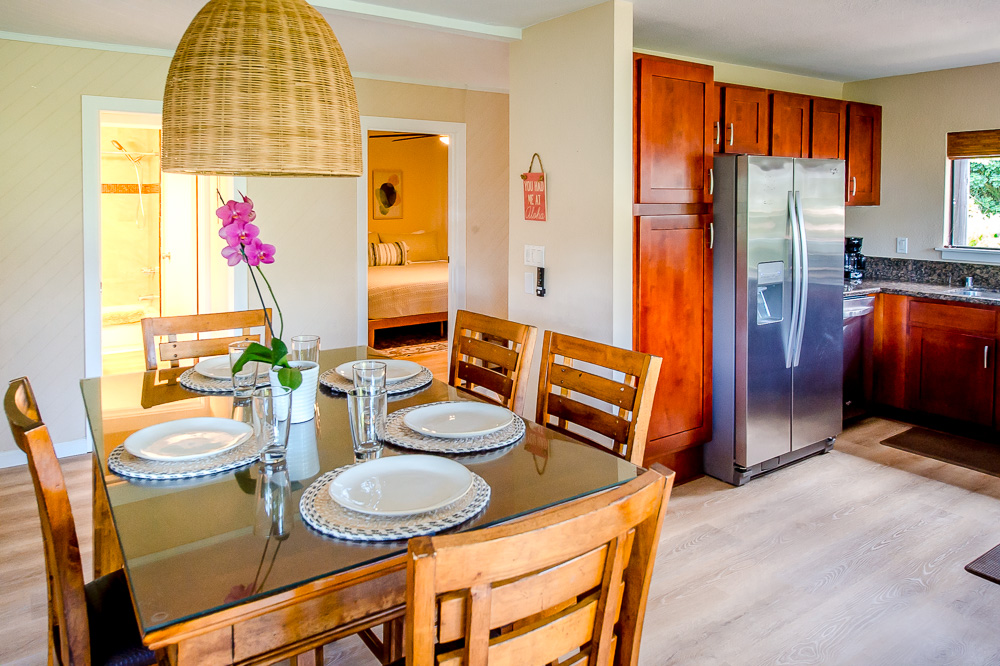3920 Wyllie Road, Unit 9A Princeville, HI 96722 - Photo 7 of 30 a dining room with furniture and wooden floor