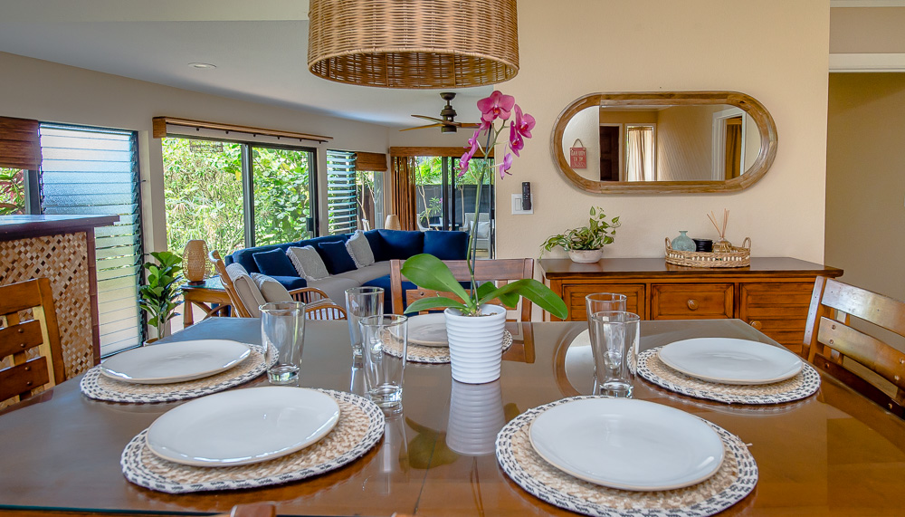 3920 Wyllie Road, Unit 9A Princeville, HI 96722 - Photo 9 of 30 a dining room with furniture a fireplace and wooden floor