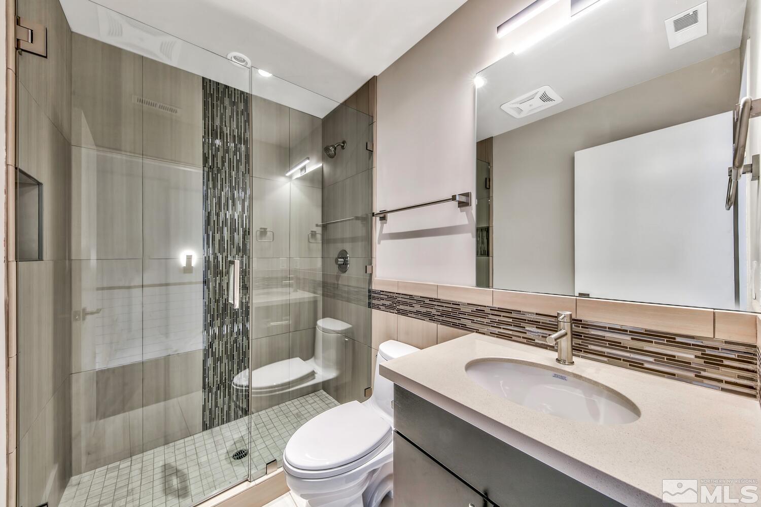 106 High Street Reno, NV 89502 - Photo 16 of 21 a bathroom with a sink a toilet and shower