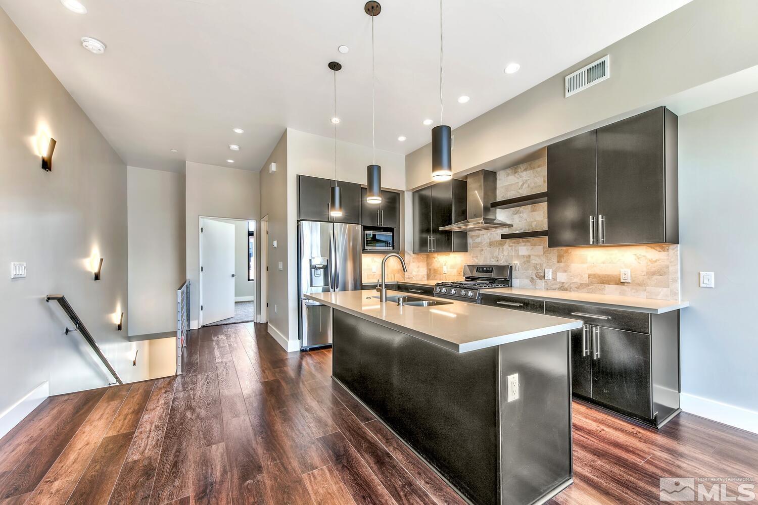 106 High Street Reno, NV 89502 - Photo 9 of 21 a kitchen with stainless steel appliances granite countertop a sink stove and refrigerator