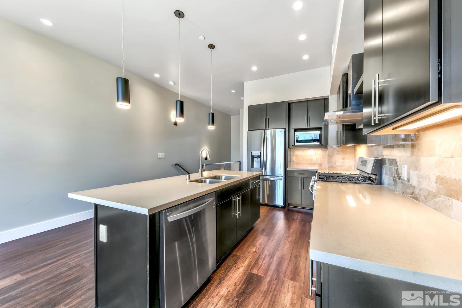 106 High Street Reno, NV 89502 - Photo 10 of 21 a kitchen with stainless steel appliances granite countertop a sink a stove and a wooden floors