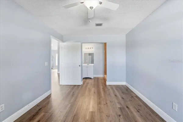 a view of a room with wooden floor and a window