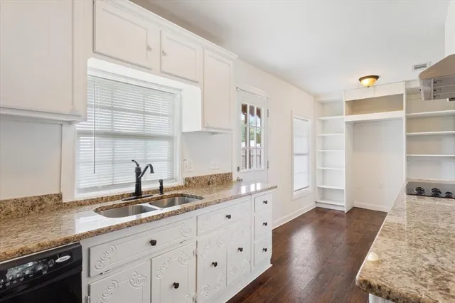 a kitchen with granite countertop a sink and a stove
