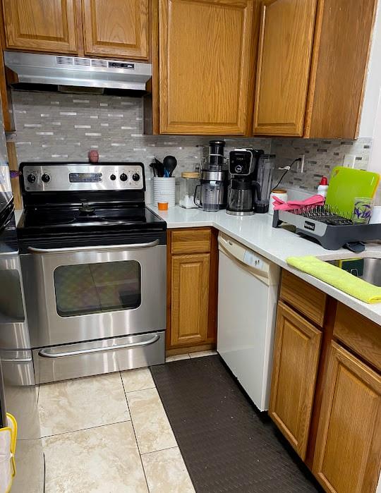 801 Lyons Road, Unit 19108 Coconut Creek, FL 33063 - Photo 19 of 42 a kitchen with stainless steel appliances granite countertop a stove a sink and a microwave