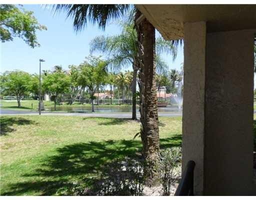 801 Lyons Road, Unit 19108 Coconut Creek, FL 33063 - Photo 20 of 42 a view of a yard with a tree
