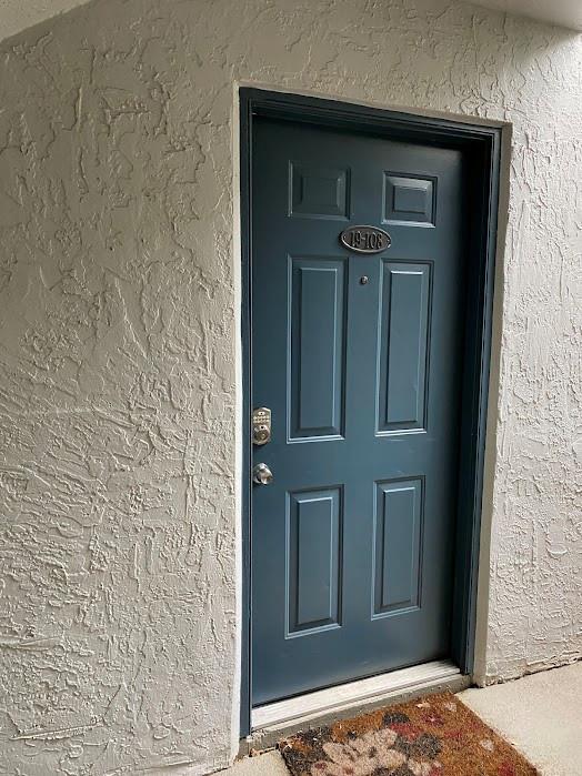 801 Lyons Road, Unit 19108 Coconut Creek, FL 33063 - Photo 22 of 42 front view of a door with the wooden door