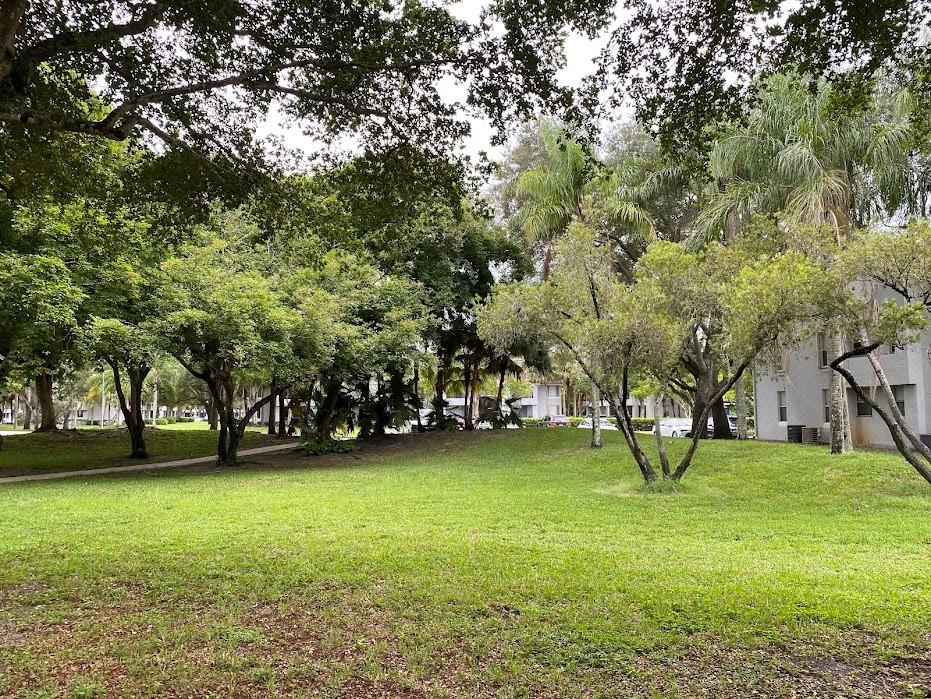 801 Lyons Road, Unit 19108 Coconut Creek, FL 33063 - Photo 30 of 42 a view of yard with swimming pool and green space