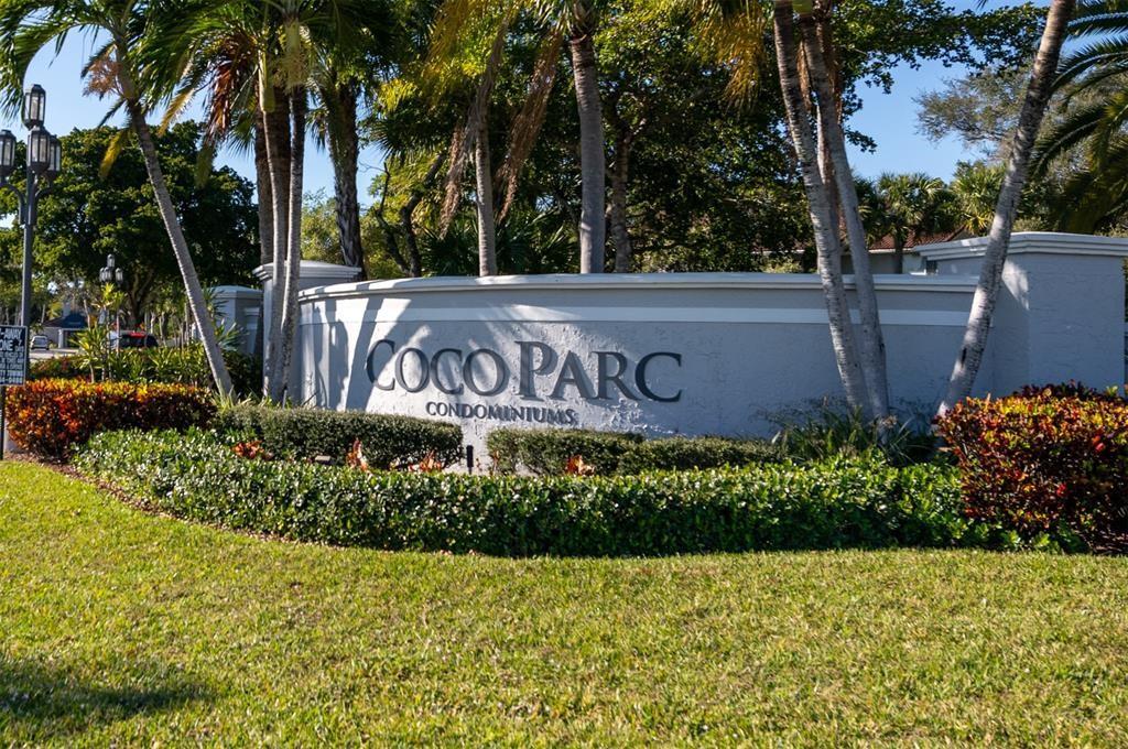 801 Lyons Road, Unit 19108 Coconut Creek, FL 33063 - Photo 3 of 42 a view of sign board with flower plants