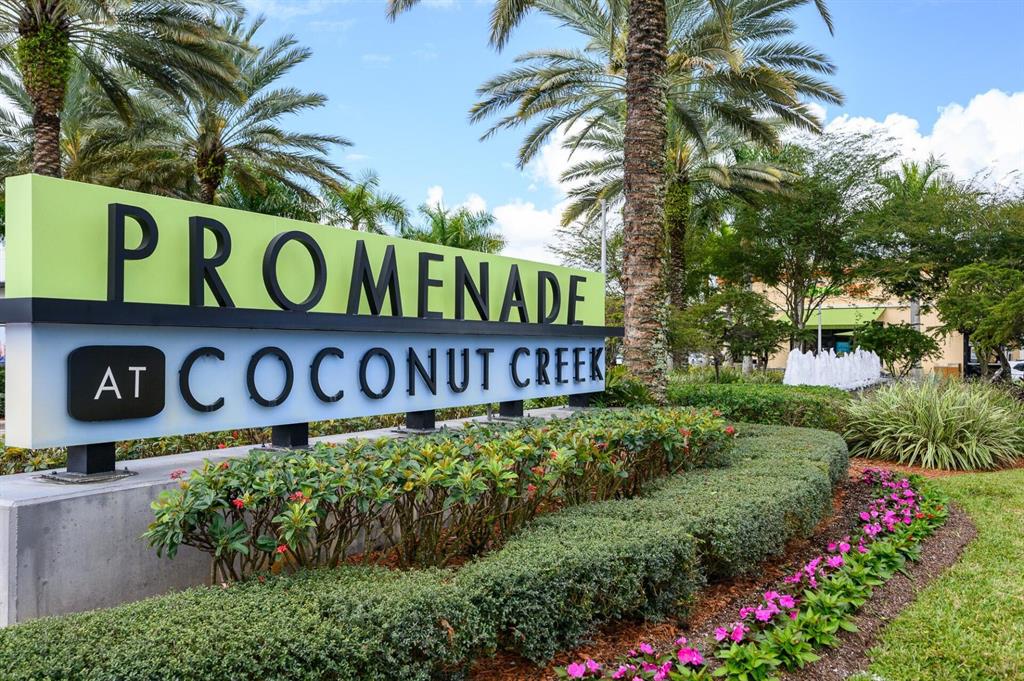 801 Lyons Road, Unit 19108 Coconut Creek, FL 33063 - Photo 36 of 42 a sign broad in front of flowers