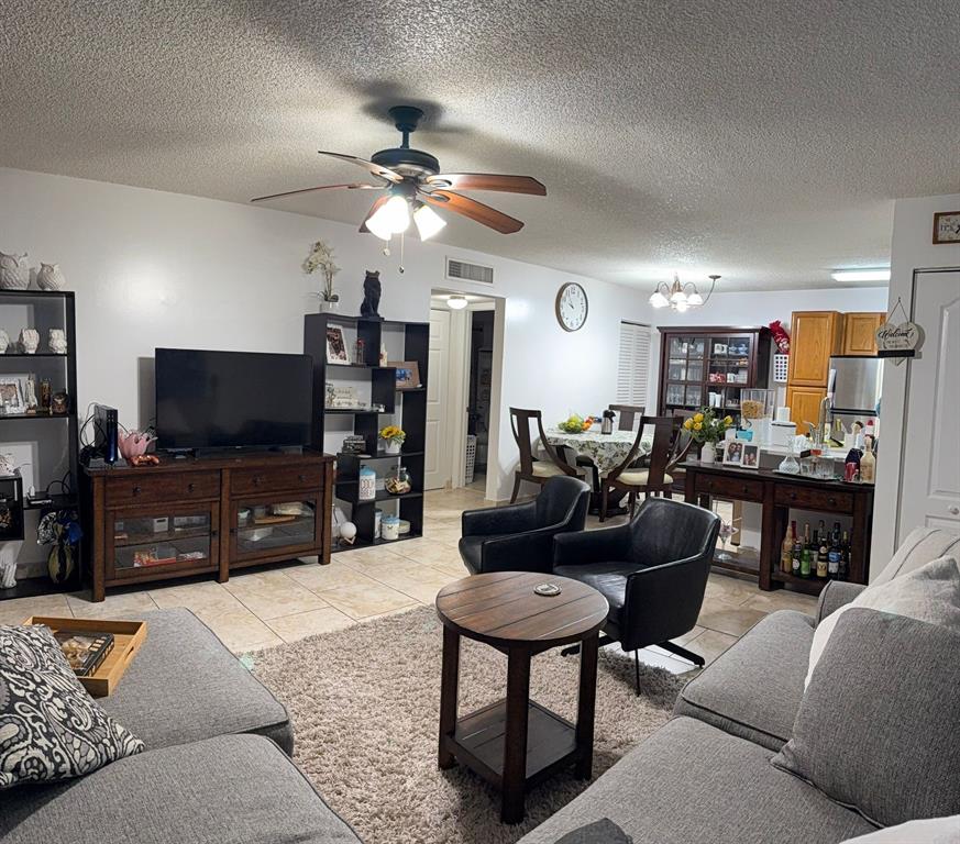 801 Lyons Road, Unit 19108 Coconut Creek, FL 33063 - Photo 5 of 42 a living room with furniture and a flat screen tv