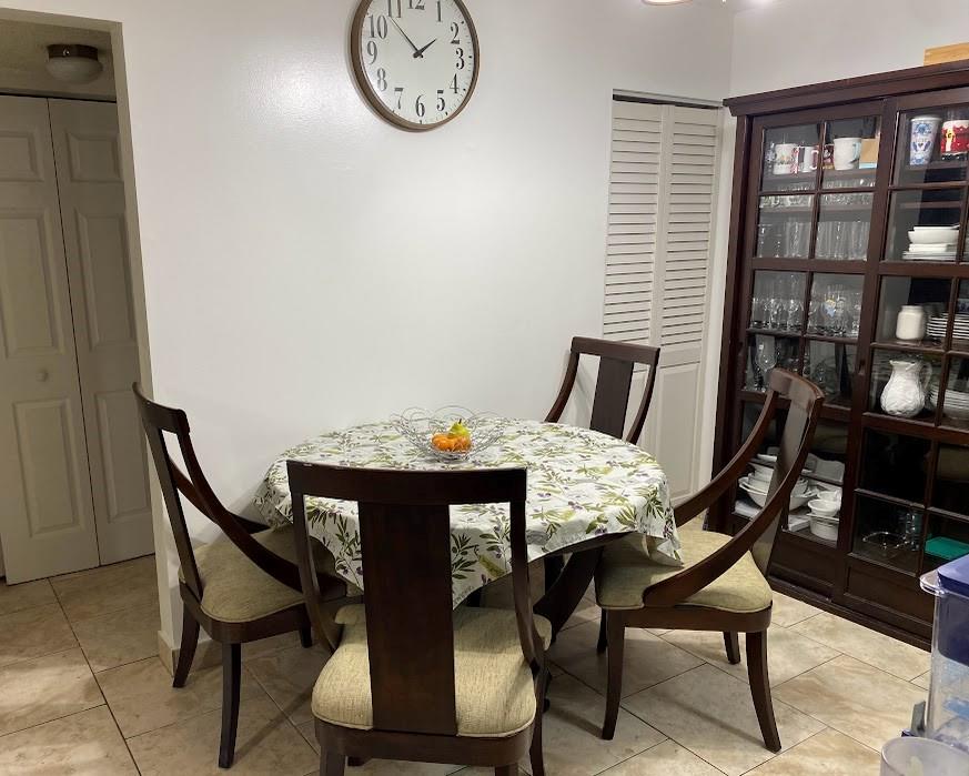 801 Lyons Road, Unit 19108 Coconut Creek, FL 33063 - Photo 6 of 42 a view of a dining room with furniture and window