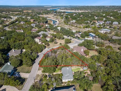 an aerial view of a house with a garden and lake view