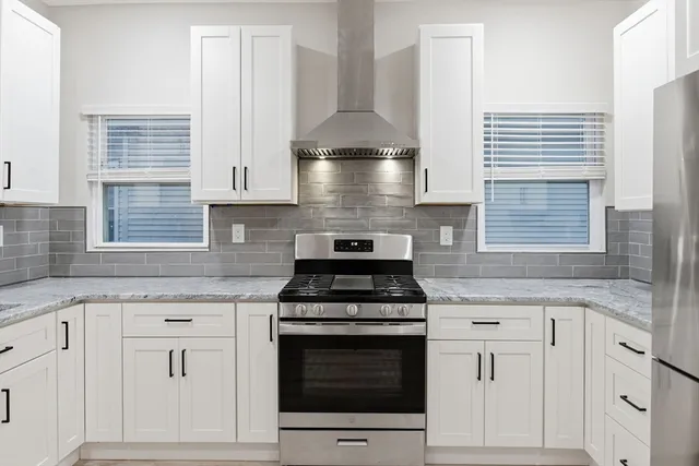 a stove top oven sitting inside of a kitchen
