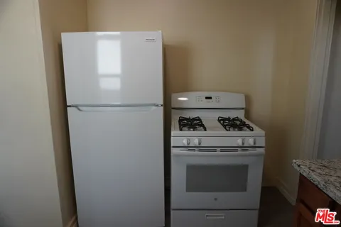a white refrigerator freezer sitting inside of a kitchen