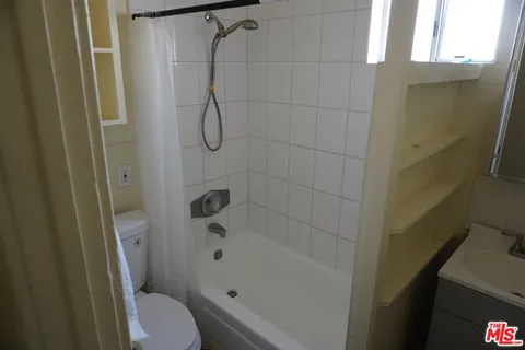 a bathroom with a shower and a toilet