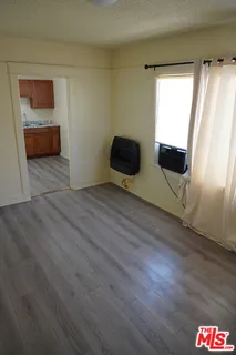 a view of a livingroom with wooden floor and windows