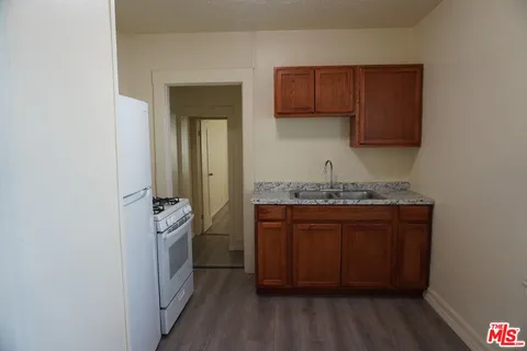 a room with granite countertop cabinets and a sink