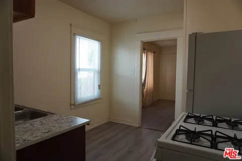 a utility room with wooden floor washer and dryer