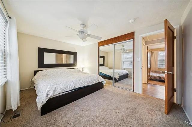 a spacious bedroom with a large bed and a chandelier
