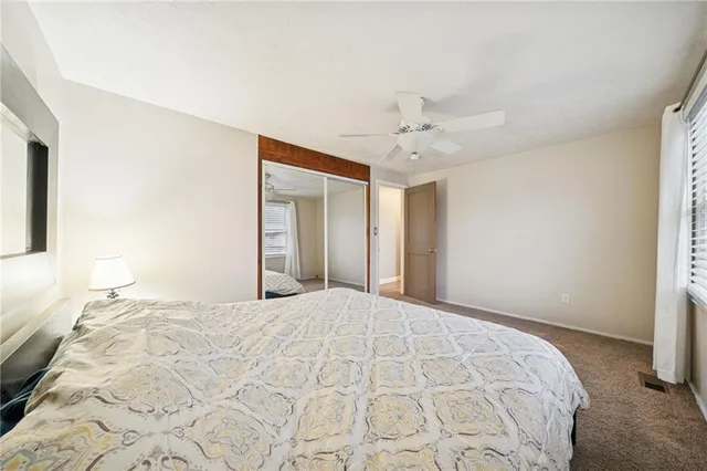 a bedroom with a large bed and a chandelier