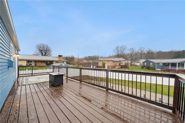 a view of balcony with wooden floor and outdoor seating