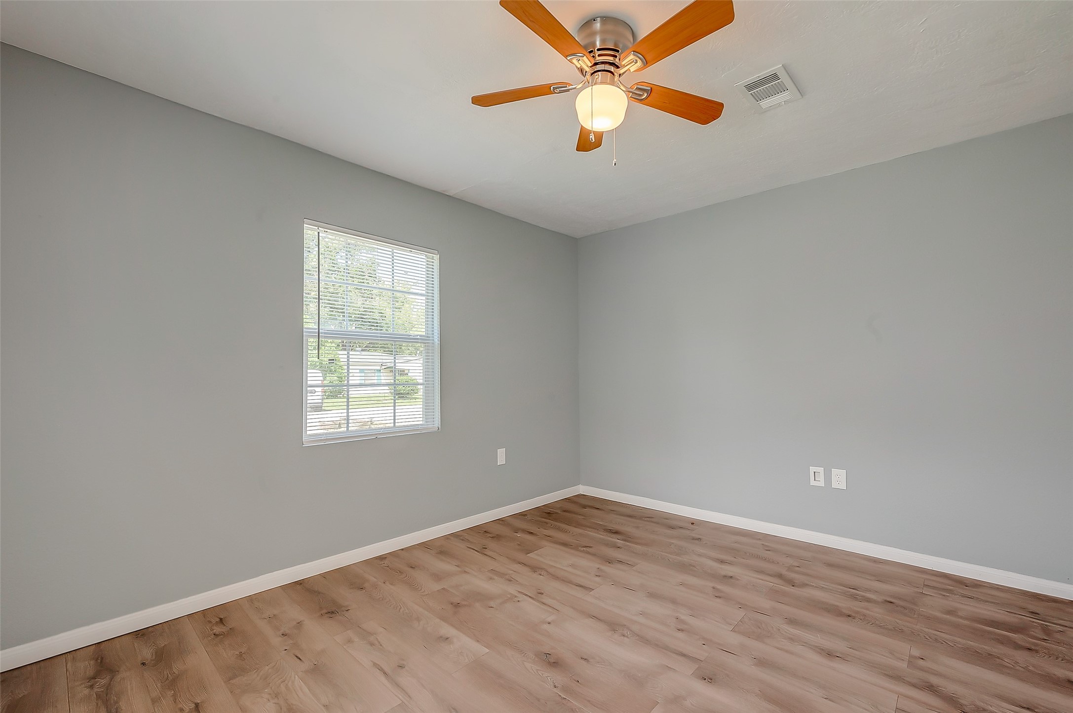 6823 Goforth Street Houston, TX 77021 - Photo 22 of 29 an empty room with wooden floor fan and windows