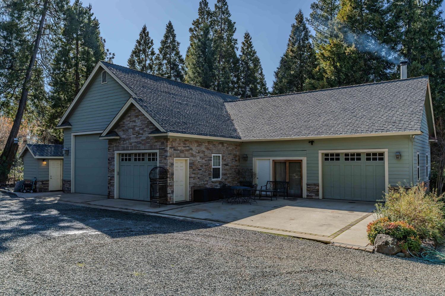 24985 Shake Ridge Road Volcano, CA 95689 - Photo 4 of 92 a front view of a house with a yard and garage