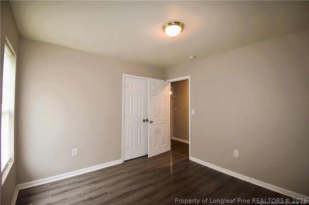 6158 Lonestar Road Fayetteville, NC 28303 - Photo 11 of 20 a view of an empty room with wooden floor and a window