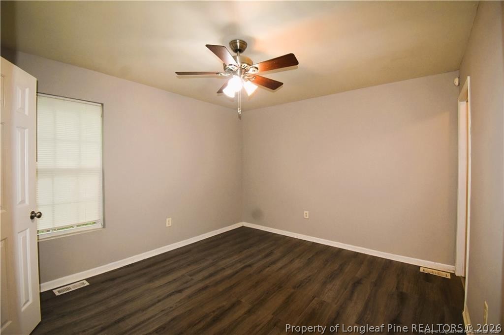 6158 Lonestar Road Fayetteville, NC 28303 - Photo 12 of 20 a view of an empty room with wooden floor