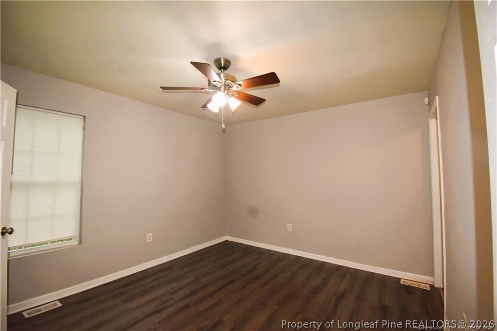 6158 Lonestar Road Fayetteville, NC 28303 - Photo 16 of 20 an empty room with wooden floor and windows