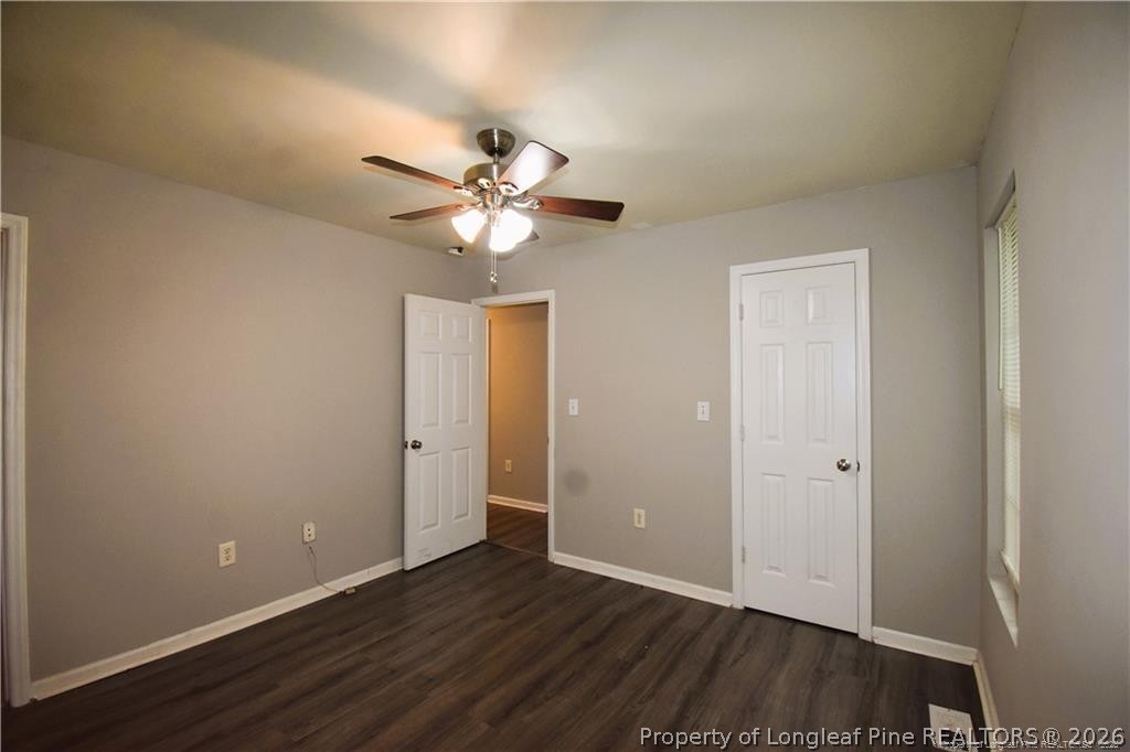 6158 Lonestar Road Fayetteville, NC 28303 - Photo 18 of 20 an empty room with wooden floor and a ceiling fan