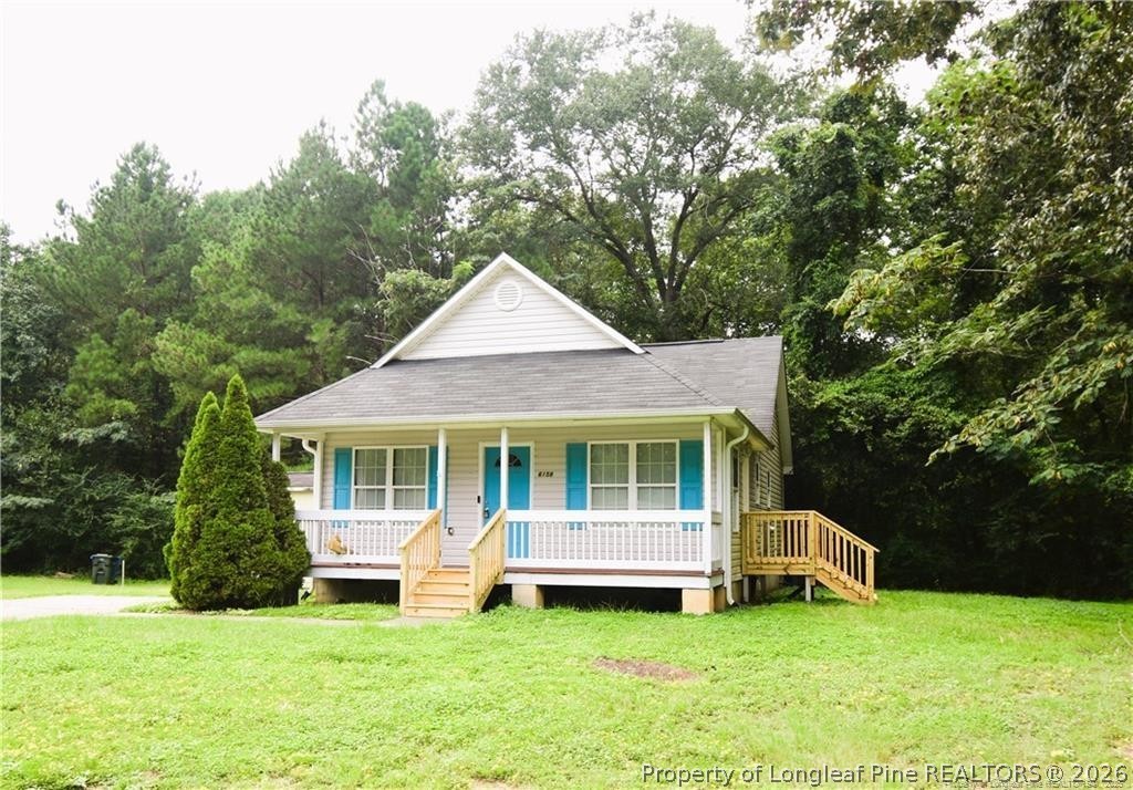 6158 Lonestar Road Fayetteville, NC 28303 - Photo 2 of 20 a front view of a house with a yard and trees