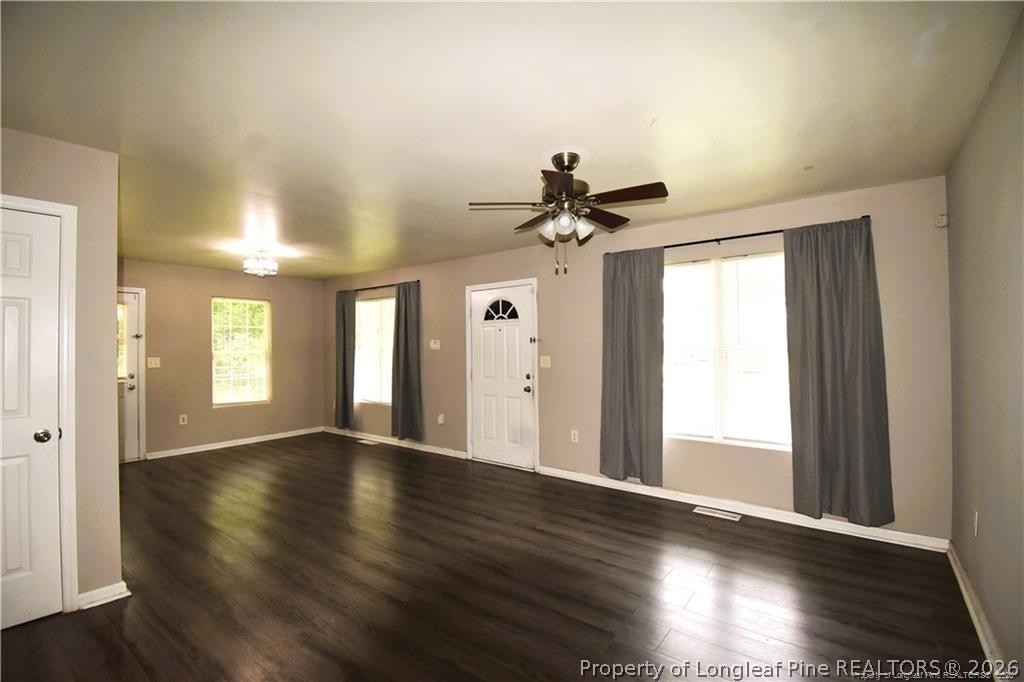 6158 Lonestar Road Fayetteville, NC 28303 - Photo 3 of 20 a view of an empty room with wooden floor and a window