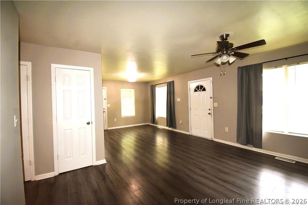 6158 Lonestar Road Fayetteville, NC 28303 - Photo 4 of 20 a view of an empty room with window and wooden floor