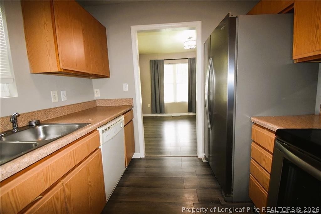 6158 Lonestar Road Fayetteville, NC 28303 - Photo 9 of 20 a kitchen with stainless steel appliances granite countertop a sink and a refrigerator