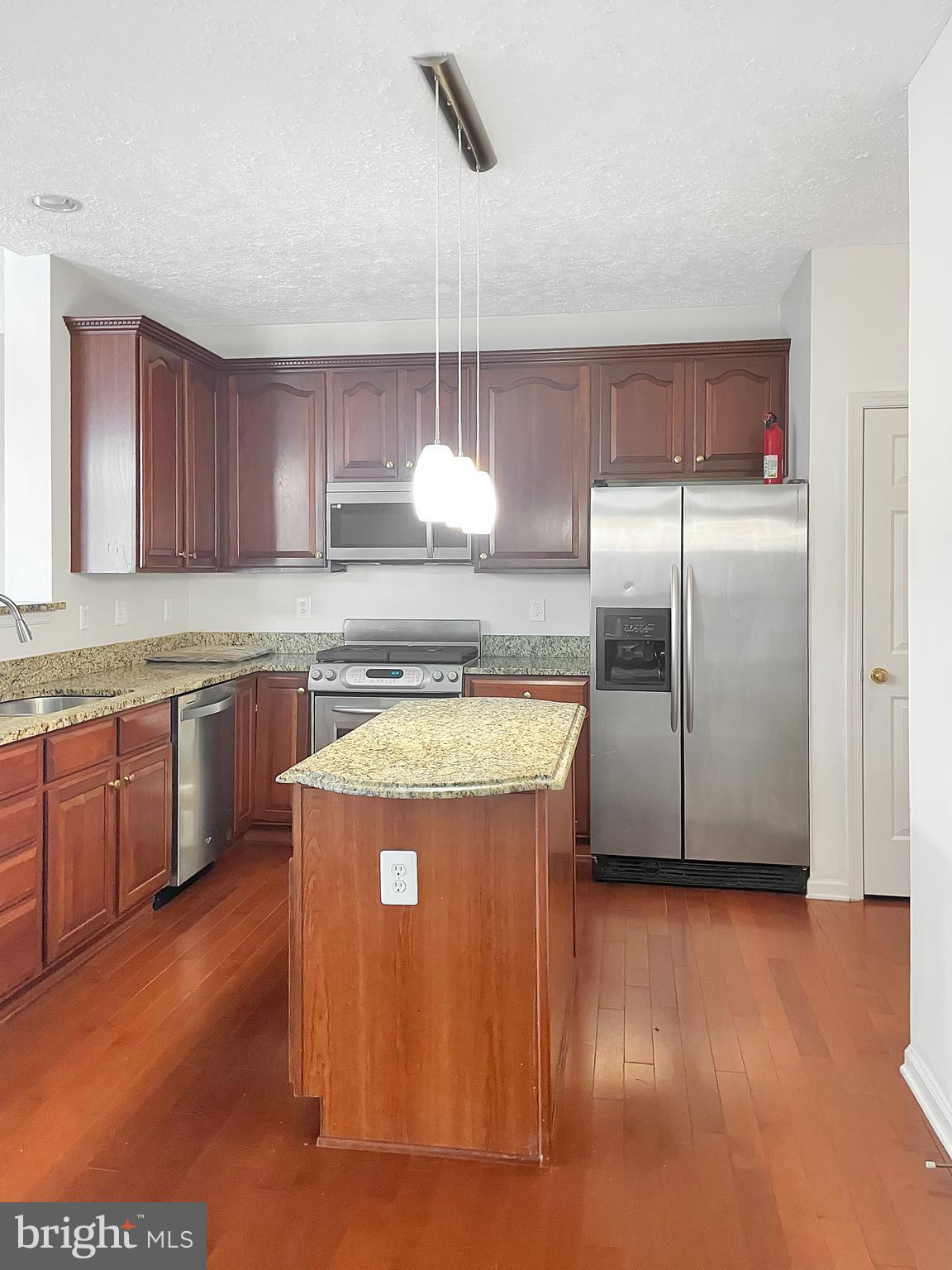 1747 Algonquin Road Frederick, MD 21701 - Photo 2 of 10 a kitchen with stainless steel appliances granite countertop a refrigerator a sink a stove a microwave and island