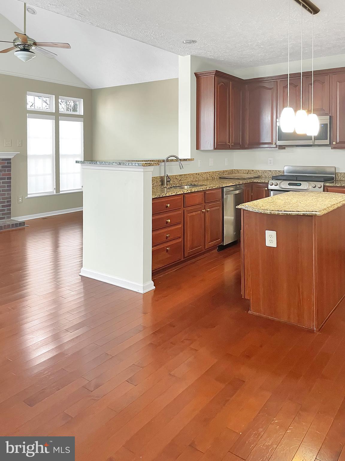 1747 Algonquin Road Frederick, MD 21701 - Photo 3 of 10 a kitchen with stainless steel appliances granite countertop a stove a sink dishwasher and a refrigerator with wooden floor