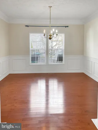 a view of wooden floor and windows in a room