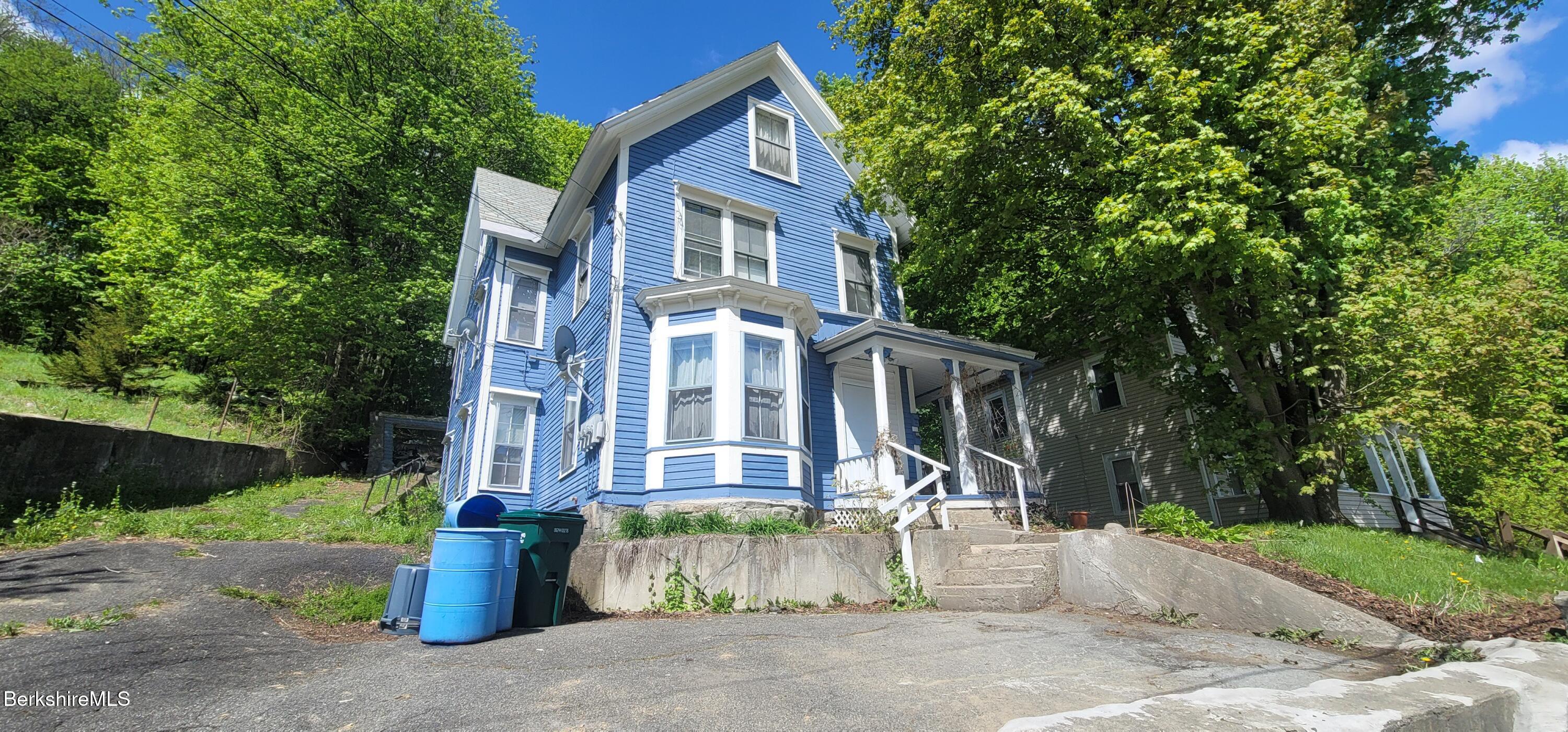 a front view of a house with a garden