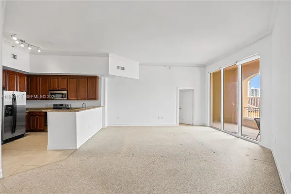 a view of kitchen with stove and cabinets