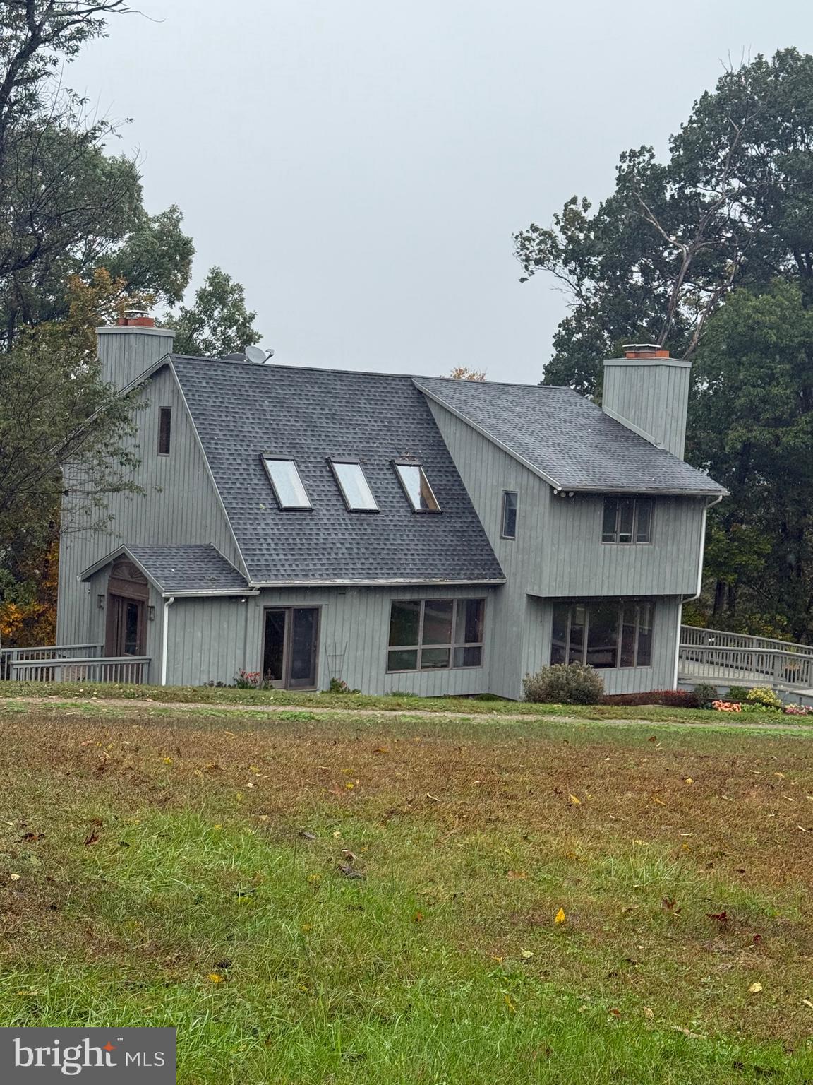a house that has a large pool in front of it