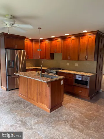 a kitchen with stainless steel appliances granite countertop a stove and a refrigerator