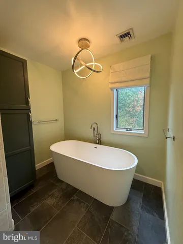 a bathroom with a white tub shower and vanity