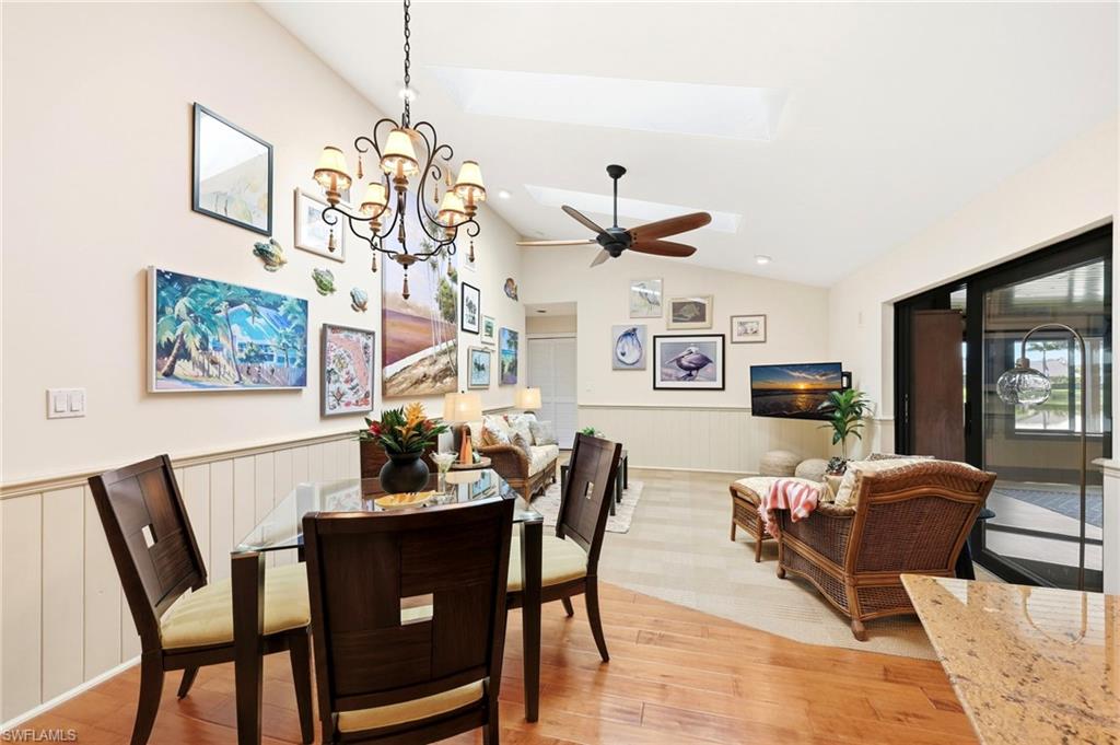 2274 Queens Way Naples, FL 34112 - Photo 11 of 28 a dining room with furniture a rug and wooden floor