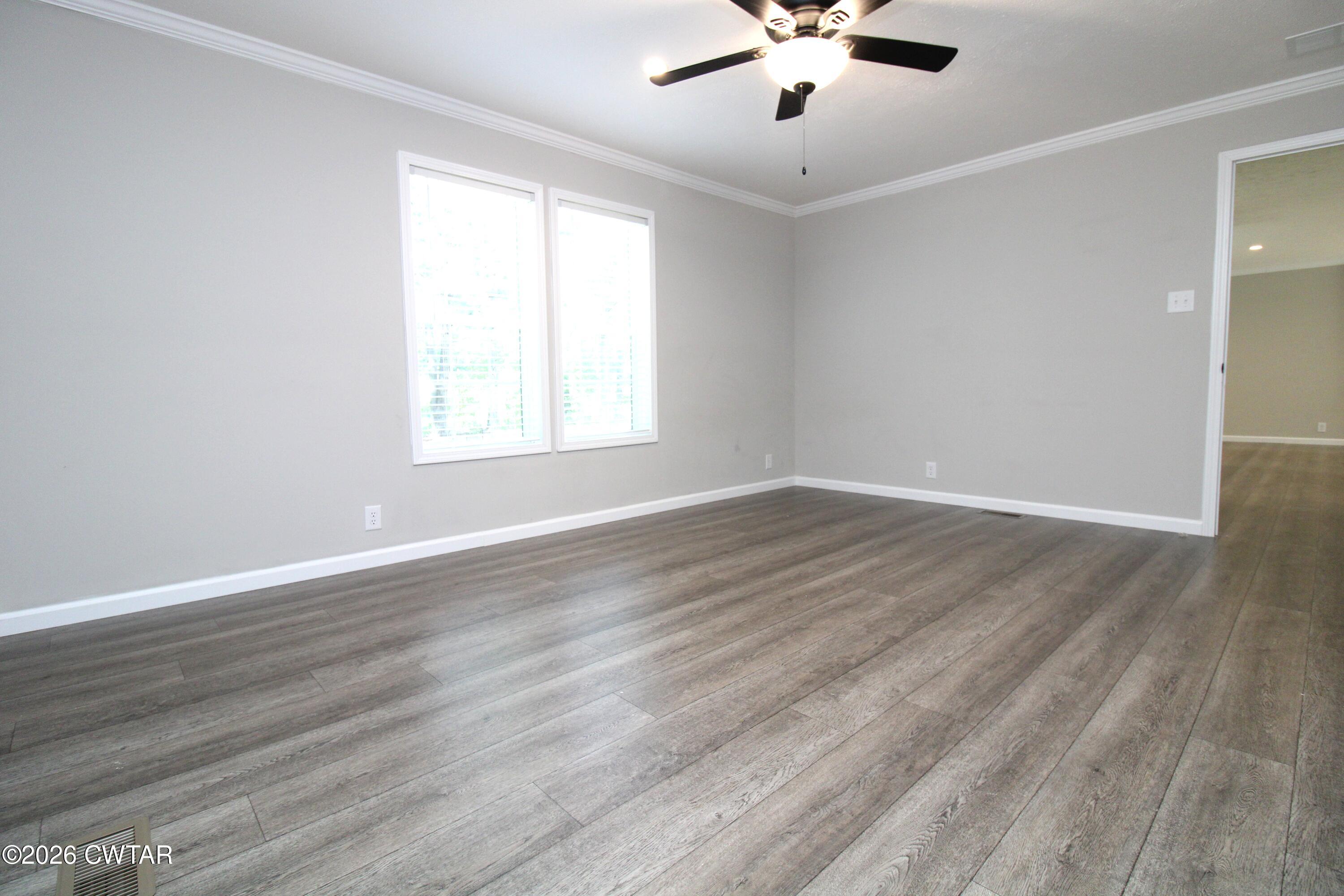 398 Pope Road Lexington, TN 38351 - Photo 10 of 21 wooden floor in an empty room with a window